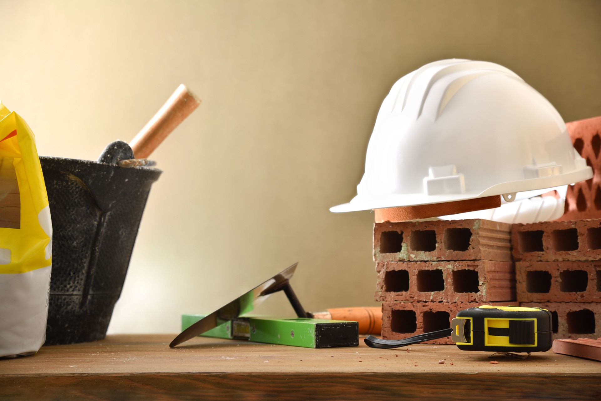 Construction materials on a wooden board and brown isolated background